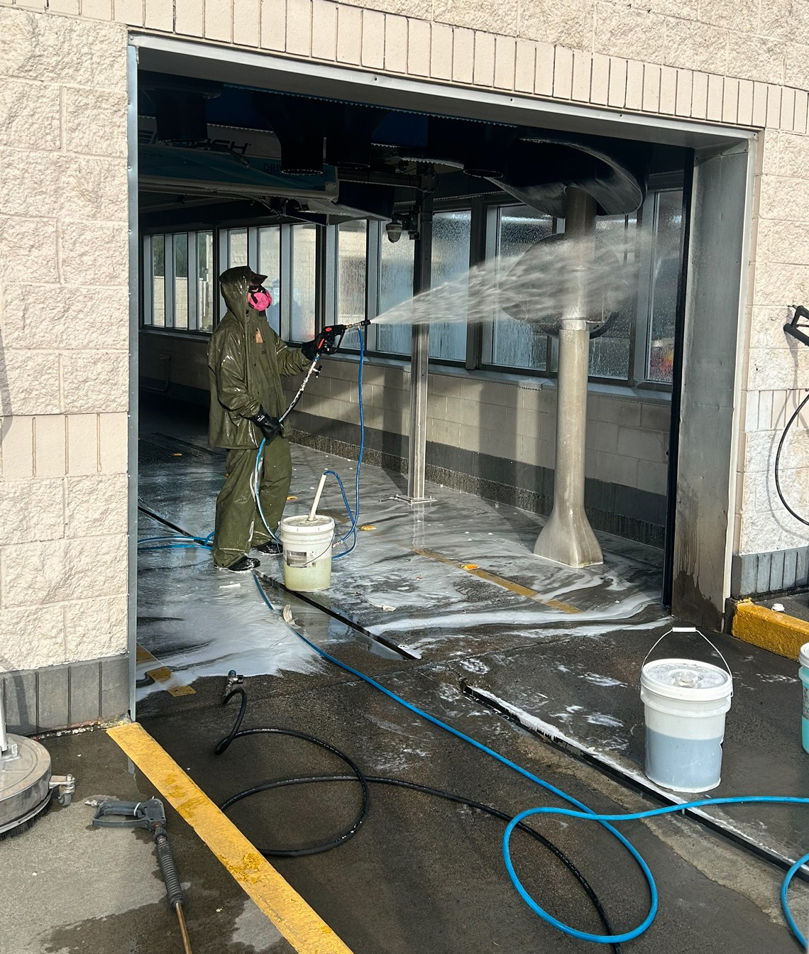 Pressure washing a car wash tunnel. Some people say power washing